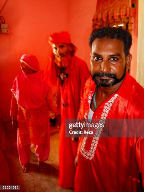 Portrait of a Malang with two of his fellows, standing by the room entrance of the sufi master Sheikh Akhtar Hussein Pirzada, titled as Noor Ali...