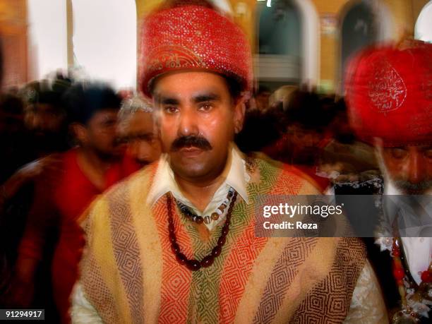 Portrait of the sufi master , Sheikh Akhtar Hussein Pirzada, titled as Noor Ali Shah, wearing his traditional dress, known as Dastar, while he pays...