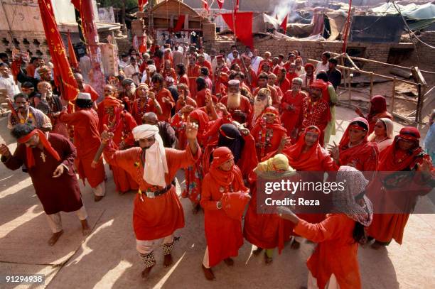 Group of dervishes dancing towards the shrine of Bodla Bahar, one of the main disciple of Lal Shahbaz Qalandar, a 13th century Sufi Master worshiped...