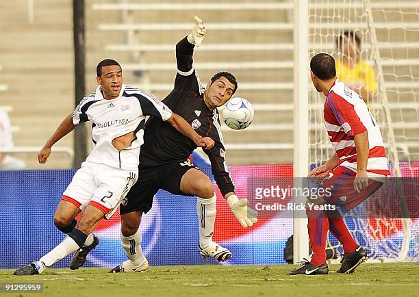 Dario Sala of the FC Dallas tries to make a save with pressure from Amaechi Igwe of the New England Revolution as Daniel Hernandez of the FC Dallas...