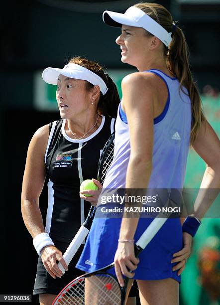 Japan's Ai Sugiyama pauses as she plays in the women's doubles quarter-final match with her partner Daniela Hantuchova of Slovakia, against Spanish...