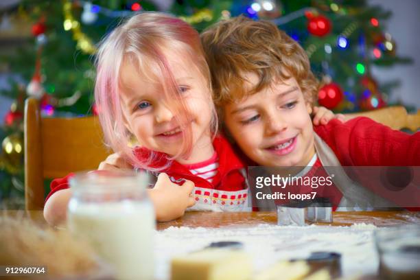 brother and sister baking cookies - naughty christmas ornaments stock pictures, royalty-free photos & images