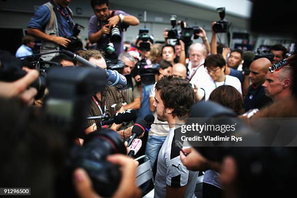 Fernando Alonso of Spain and Renault is surrounded by the media during previews to the Japanese Formula One Grand Prix at Suzuka Circuit on October...