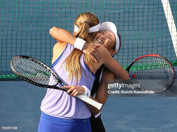 Ai Sugiyama of Japan and Daniela Hantuchova of Slovakia celebrate after their women's doubles quarter-final match against Anabel Medina Garrigues of...