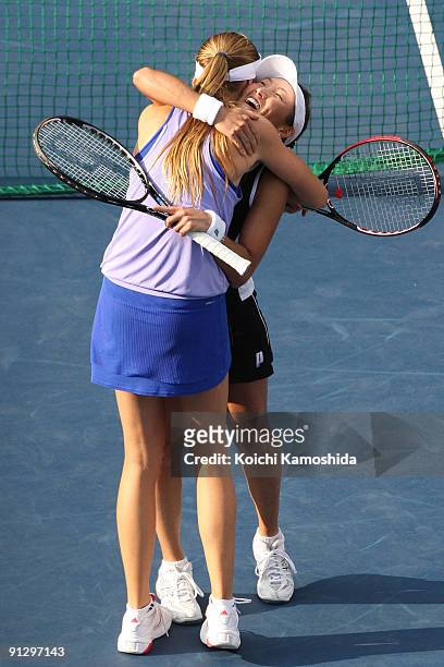 Ai Sugiyama of japan and Daniela Hantuchova of Slovakia celebrate after their women's doubles quarter-final match against Anabel Medina Garrigues of...