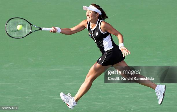 Ai Sugiyama of Japan returns a shot in the women's doubles quarter-final match with her partner Daniela Hantuchova of Slovakia against Anabel Medina...