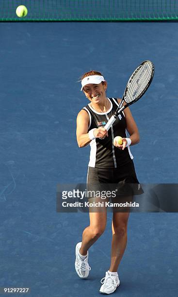 Ai Sugiyama of Japan smiles following her doubles match with Daniela Hantuchova of Slovakia after winning their women's doubles quarter-final match...
