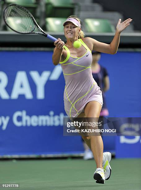 Maria Sharapova of Russia returns to Iveta Benesova of the Czech Republic during their women's singles quarter-final match in the Pan Pacific Open...