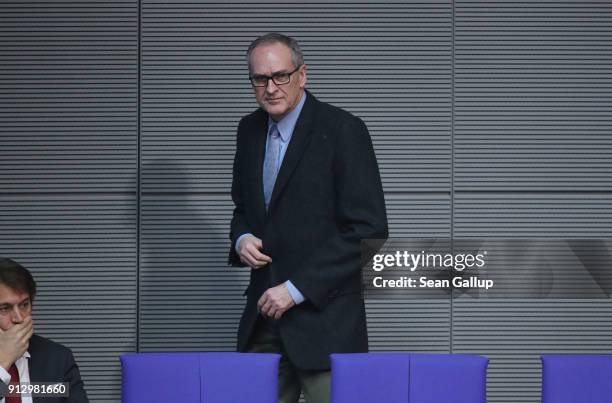 Roman Reusch of the right-wing Alternative for Germany political party walks in the back of the Bundestag shortly after he was elected to the...