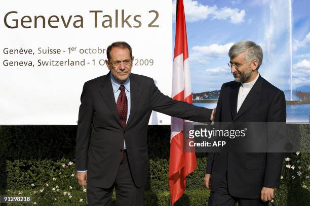 European Union foreign affairs chief Javier Solana poses with Iran's top nuclear negotiator Saeed Jalili in front of a banner with a picture of the...