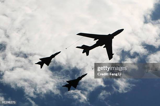 Planes from the Chinese People's Liberation Army air force fly in formation during a massive parade to celebrate the 60th anniversary of the founding...