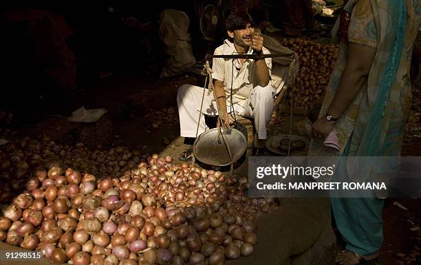 An Indian man sells produce at a vegetable market in New Delhi on October 1, 2009. Indian inflation accelerated sharply as the weakest monsoon in...