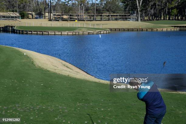 Driver Denny Hamlin hits balls on the 17th hole at THE PLAYERS Stadium Course at TPC Sawgrass on January 31, 2018 in Ponte Vedra Beach, Florida.