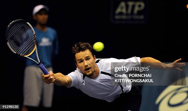 Swiss player Macro Chiudinelli returns to Marat Safin of Russia during their second round ATP Thailand Open tennis match in Bangkok on October 01,...