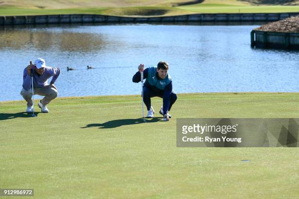 Driver Denny Hamlin and PGA TOUR golfer Sam Saunders on the 17th hole at THE PLAYERS Stadium Course at TPC Sawgrass on January 31, 2018 in Ponte...