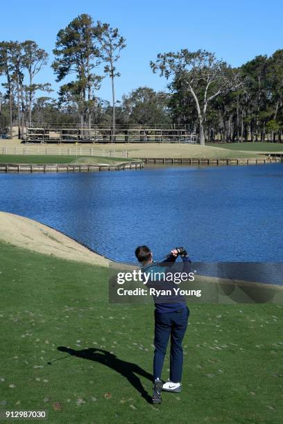 Driver Denny Hamlin plays on the 17th hole at THE PLAYERS Stadium Course at TPC Sawgrass on January 31, 2018 in Ponte Vedra Beach, Florida.