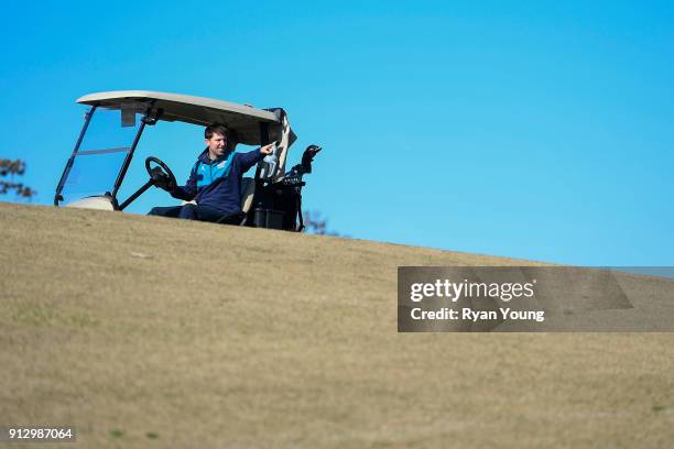 Driver Denny Hamlin drives a golf cart on the 17th hole at THE PLAYERS Stadium Course at TPC Sawgrass on January 31, 2018 in Ponte Vedra Beach,...