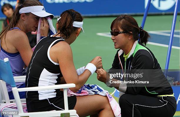 Ai Sugiyama of Japan talks to her coach and mother Fusako Sugiyama during her doubles match with her partner Daniela Hantuchova of Slovakia against...