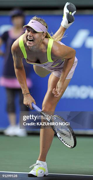 Maria Sharapova of Russia serves to Iveta Benesova of the Czech Republic during their women's singles quarter-final match in the Pan Pacific Open...