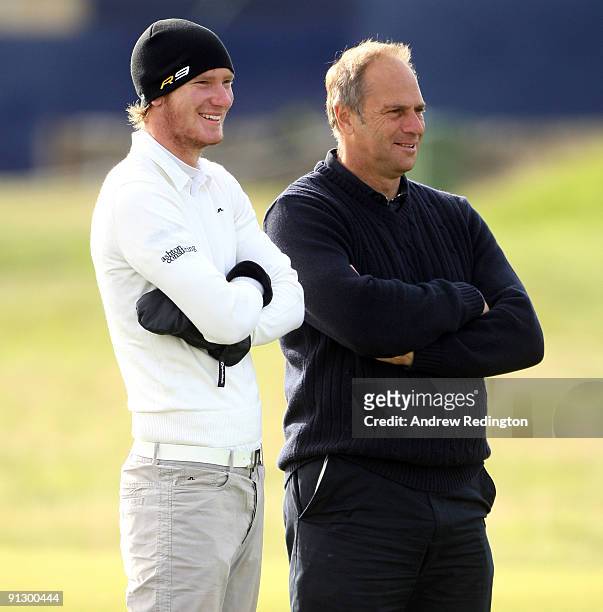 Chris Wood of England chats with Sir Steve Redgrave, former British Olympic rowing champion, on the second hole during the first round of The Alfred...