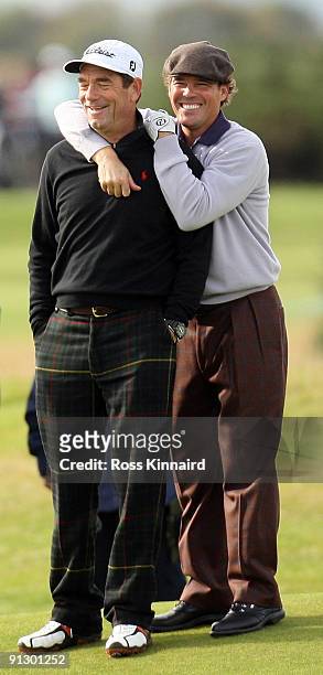 Pop singer Huey Lewis shares ajoke with US country singer Clay Walker on the 15th hole during the first round of The Alfred Dunhill Links...