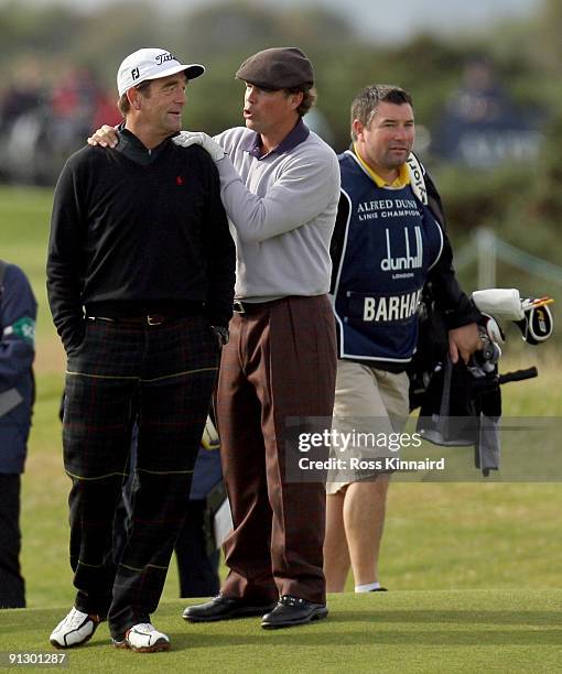 Pop singer Huey Lewis shares ajoke with US country singer Clay Walker on the 15th hole during the first round of The Alfred Dunhill Links...