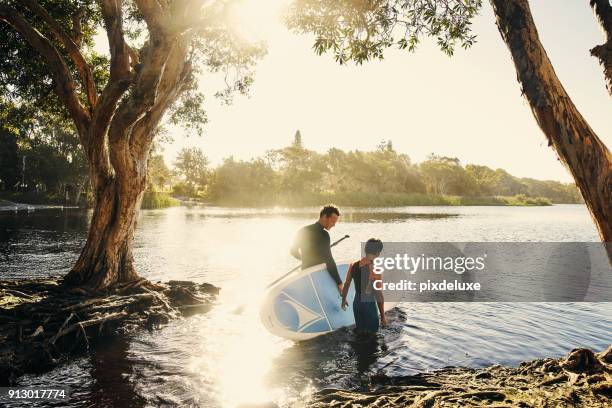 everything changes when your board touches the water - family paddleboard stock pictures, royalty-free photos & images