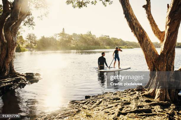 if in doubt my boy paddle out - paddleboarding australia stock pictures, royalty-free photos & images