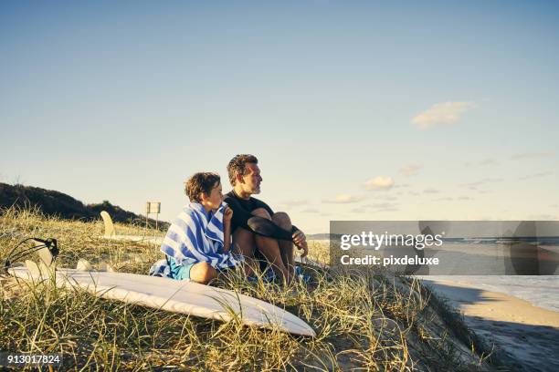 watching the waves together - young australian man stock pictures, royalty-free photos & images