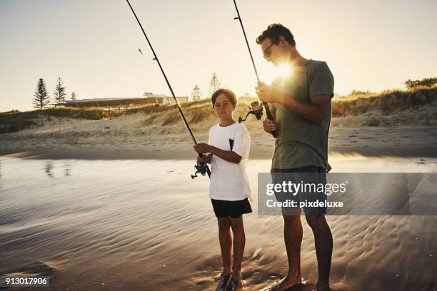 teaching him how to fish is the best lesson - fishing australia stock pictures, royalty-free photos & images