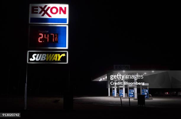 An Exxon Mobil Corp. Gas station stands illuminated at night in Nashport, Ohio, U.S., on Friday, Jan. 26, 2018. Exxon Mobil Corp. Is scheduled to...