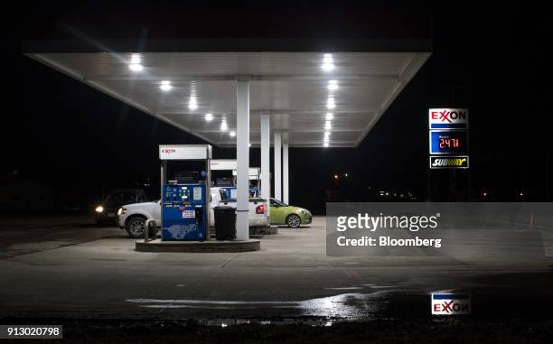 Customers fuel vehicles at an Exxon Mobil Corp. Gas station in Nashport, Ohio, U.S., on Friday, Jan. 26, 2018. Exxon Mobil Corp. Is scheduled to...