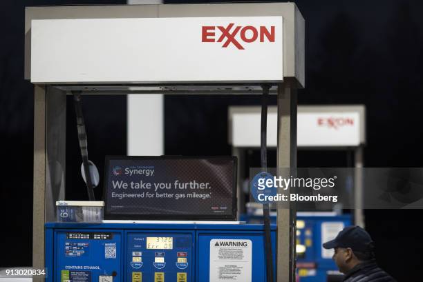 Signage is displayed on a fuel pump at an Exxon Mobil Corp. Gas station in Nashport, Ohio, U.S., on Friday, Jan. 26, 2018. Exxon Mobil Corp. Is...