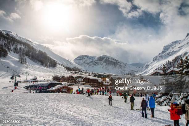 crowd of tourists enjoying and skiing in val d'isere french ski resort in alps mountains in winter - espace killy stock pictures, royalty-free photos & images
