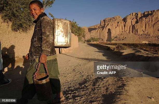 Afghanistan-unrest-NZealand-military-development,FOCUS by Lynne O'Donnell This photograph taken on September 25 a Hazara youth walks in front of the...