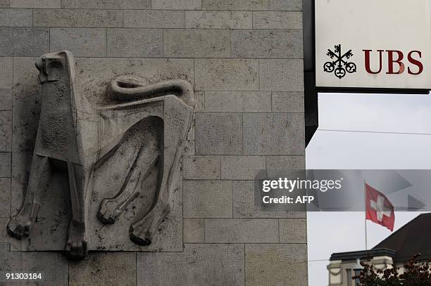 View of the logo of UBS swiss bank and swiss flag in Zurich on October 1, 2009. Switzerland's stock exchange is investigating banking giant UBS for...