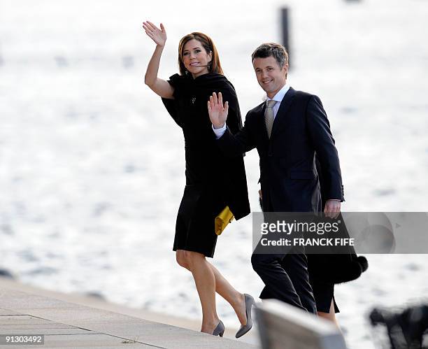 Danish Crown Princess Mary and Danish Crown Prince Frederik wave after arriving by boat for the opening ceremony of the 121st session of the...