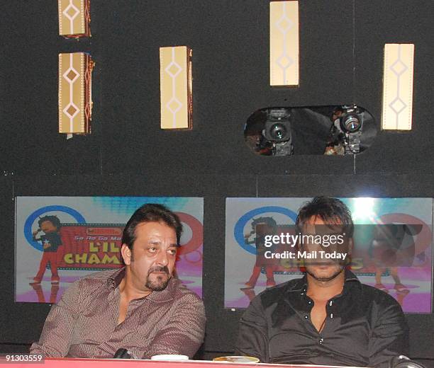 Actors Sanjay Dutt and Ajay Devgan pose on the sets of the music show Little Champs in Mumbai on Tuesday, September 29, 2009.