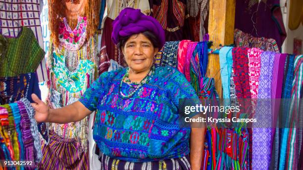 senior mayan woman selling handmade textiles and souvenirs, panajachel, guatemala - guatemala photos et images de collection