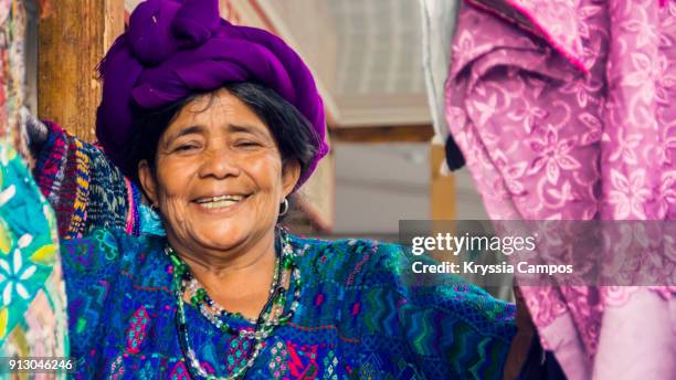 senior mayan woman selling handmade textiles and souvenirs, panajachel, guatemala - maya guatemala stock pictures, royalty-free photos & images