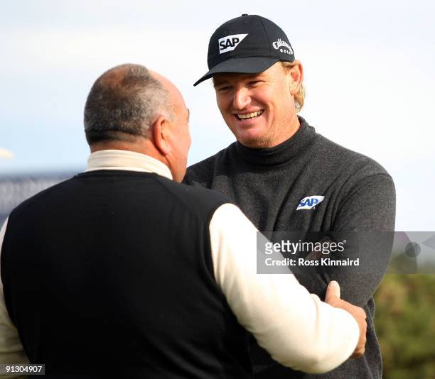 Andrew Chandler, Managing Director of ISM chats with Ernie Els of South Africa during the first round of The Alfred Dunhill Links Championship at...