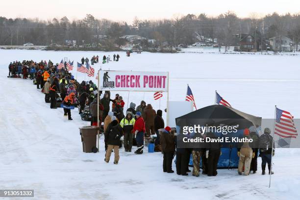 Brainerd Jaycees Ice Fishing Extravaganza: View of contestants lined up at check point during event on Brainerd Lakes. Contestants came from 38...
