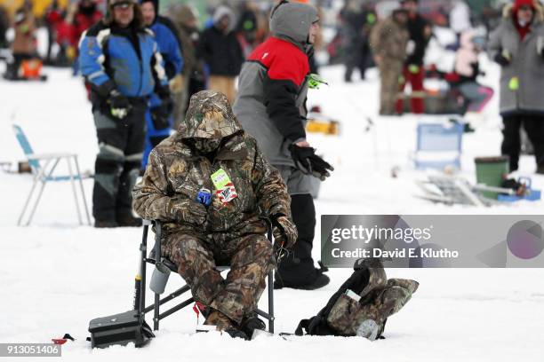 Brainerd Jaycees Ice Fishing Extravaganza: View of contestant seated and drinking a beer during event on Brainerd Lakes. Contestants came from 38...