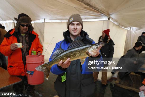 Brainerd Jaycees Ice Fishing Extravaganza: View of contestant holding a Walleye fish after placing second overall during event on Brainerd Lakes....