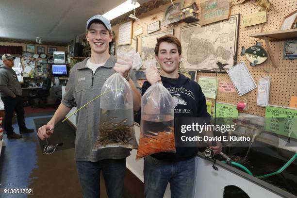 Brainerd Jaycees Ice Fishing Extravaganza: Closeup of contestants holding "Silver Shiners" and "Rosie Reds" at S&W Bait and Tackle to be used as live...