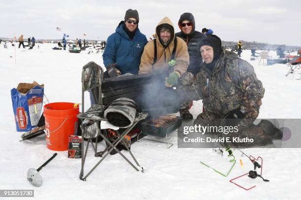 Brainerd Jaycees Ice Fishing Extravaganza: Contestants pose with grilled food and beers during event on Brainerd Lakes. Contestants came from 38...