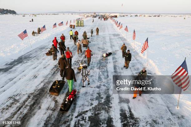 Brainerd Jaycees Ice Fishing Extravaganza: Contestants carry equipment on sleds during event on Brainerd Lakes. Contestants came from 38 states and...