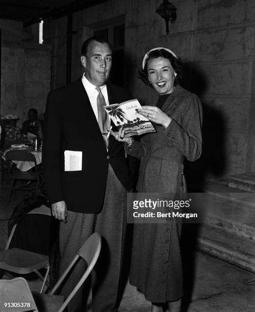 Portrait of American baseball team owner Daniel Reid Topping and his wife, actress Kay Sutton , as they pose together at Hialeah Park Race Track,...