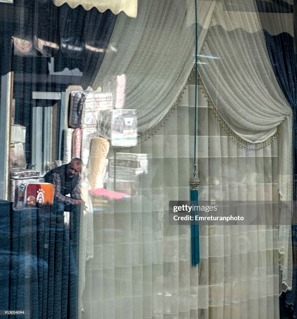 Reflections of a salesman on shop window,Kemeralti.