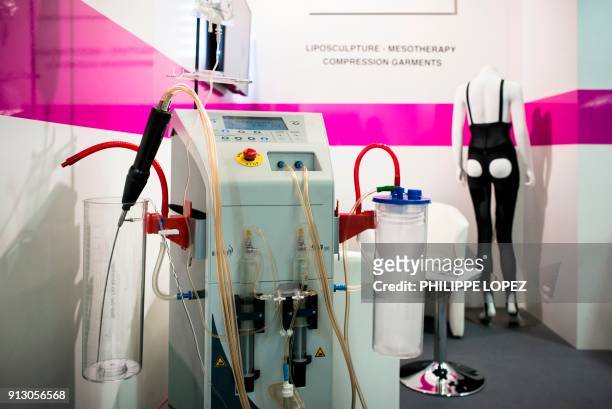 Picture takenon February 1, 2018 shows a liposuction aesthetic surgery machine displayed at a booth of the Aesthetic science, plastic surgery and...